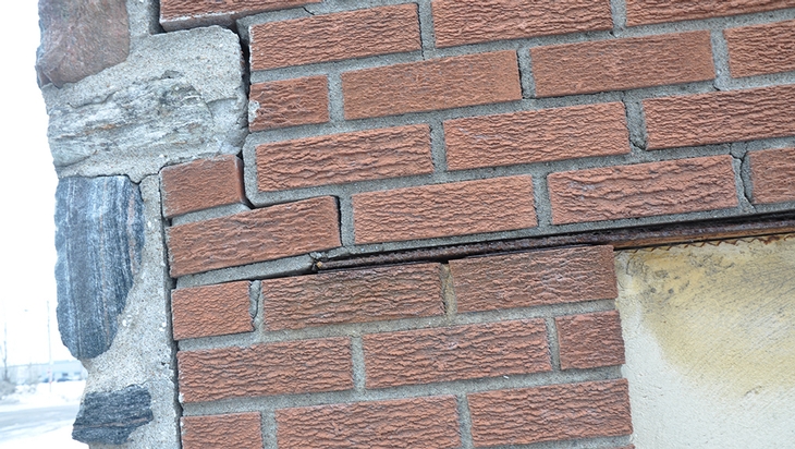 Early indication of masonry parts coming off the facade of the building